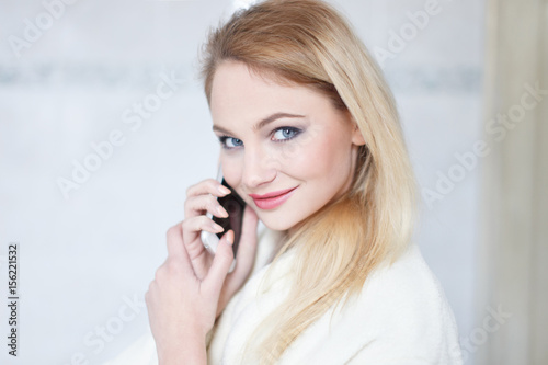Blonde woman calling in bathroom