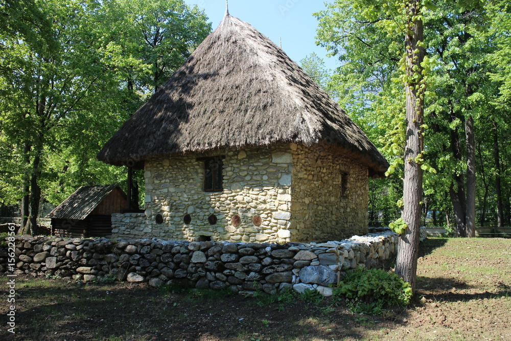 House with straw roof in Dimitrie Gusti National Village Museum in Bucharest, Romania 