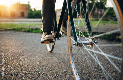 Fototapeta Naklejka Na Ścianę i Meble -  Riding bicycle at sunset