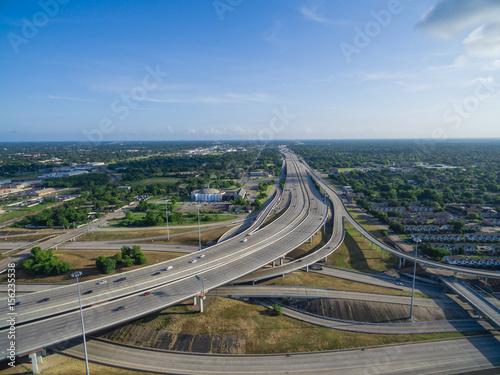 Aerial view massive interstate I69 highway intersection, stack interchange with elevated road junction overpass in downtown Houston. This five-level freeway interchange carry heavy rush hour traffic. photo