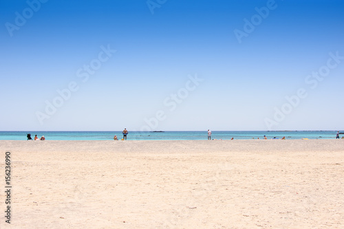 Sandy beach on an island with blue sea and blue sky