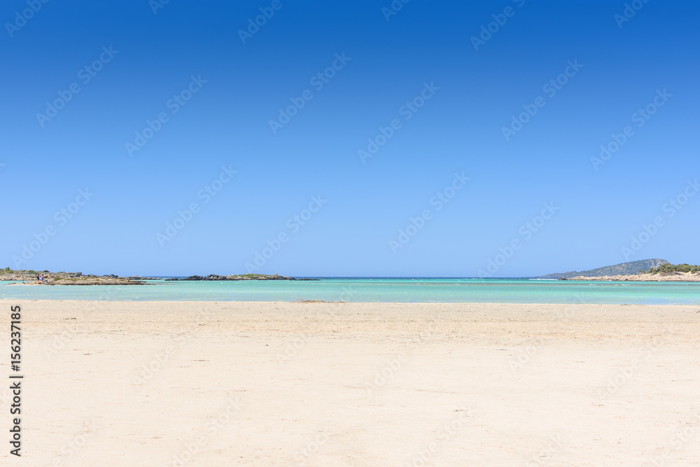 Sandy beach on an island with blue sea and blue sky