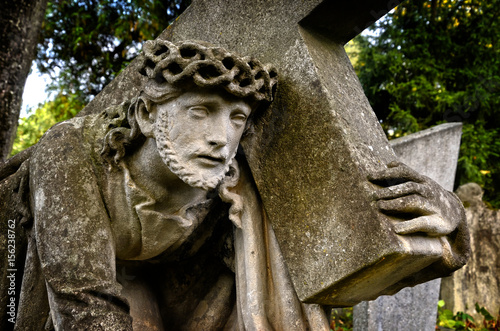 Jesus bearing the cross. Stone sculpture.