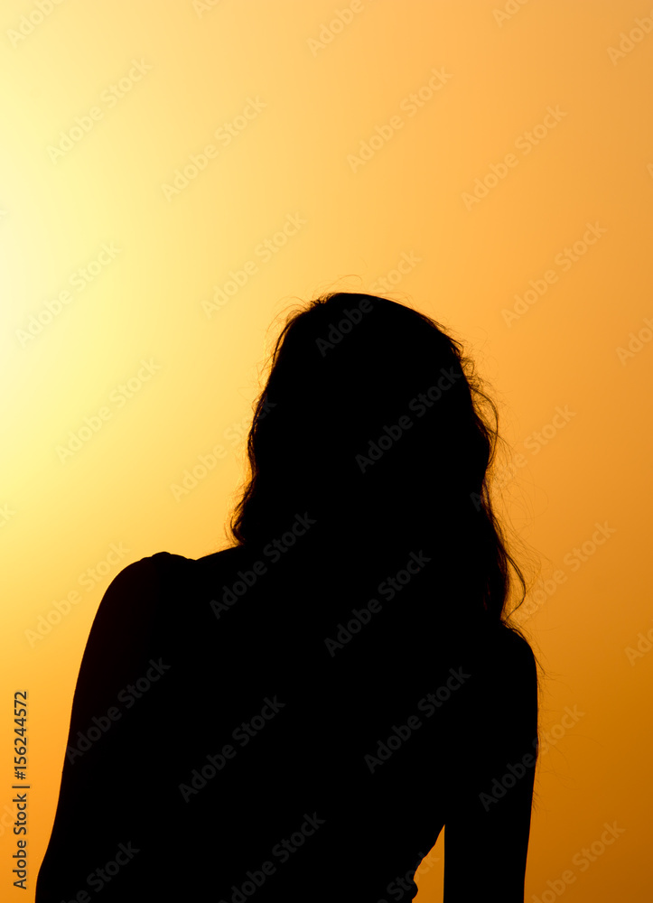 Silhouette of a beautiful girl at sunset