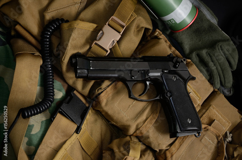 Pistol gun with military equipment.
