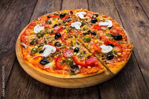 Delicious pizza with salami, mushrooms and olives