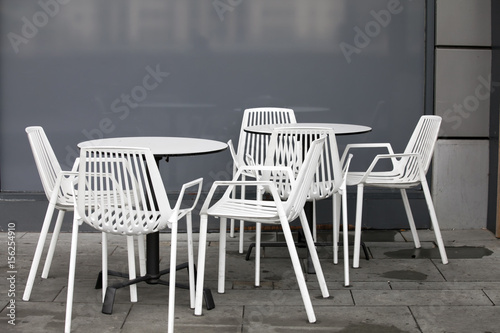 the Restaurant zone with white plastic chairs and white tables in the lobby of the mall. Beautiful interior