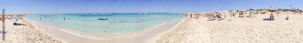 FORMENTERA, SPAIN - JUNE 2015: Tourists enjoy wonderful island beach, panoramic view. Formentera is a famous tourist destination in Spain