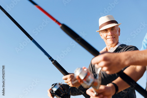 Senior man fishing at sea side