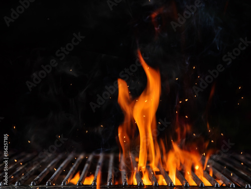 Empty flaming charcoal grill with open fire