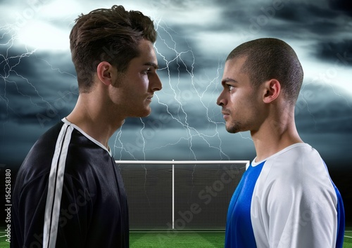 soccer players with storm behind them, looking each other
