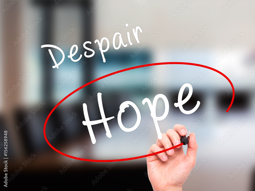 Man Hand writing and choosing Hope instead of Despair with black marker on visual screen Man Hand writing and choosing Hope instead of Despair with black marker on visual screen