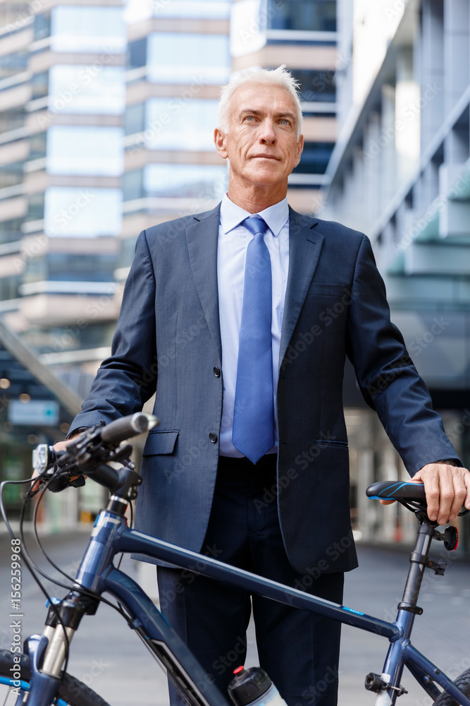 Successful businessman riding bicycle Successful businessman riding bicycle