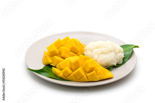 Isolated dish of carve beautiful yellow mango with sticky rice on white background