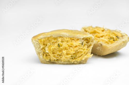 One cut traditional Brazilian mini chicken pie called empada in white background