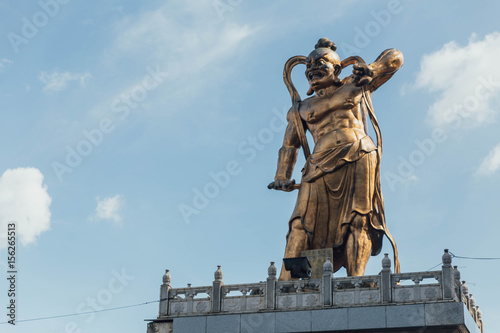 Golden Guanyin's guardian statue at octagonal pavilion in Kek Lok Si Temple at George Town. Panang, Malaysia.