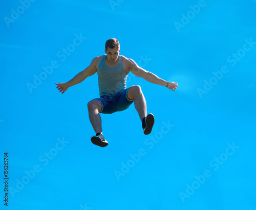 Jumping up guy. Background blue sky.