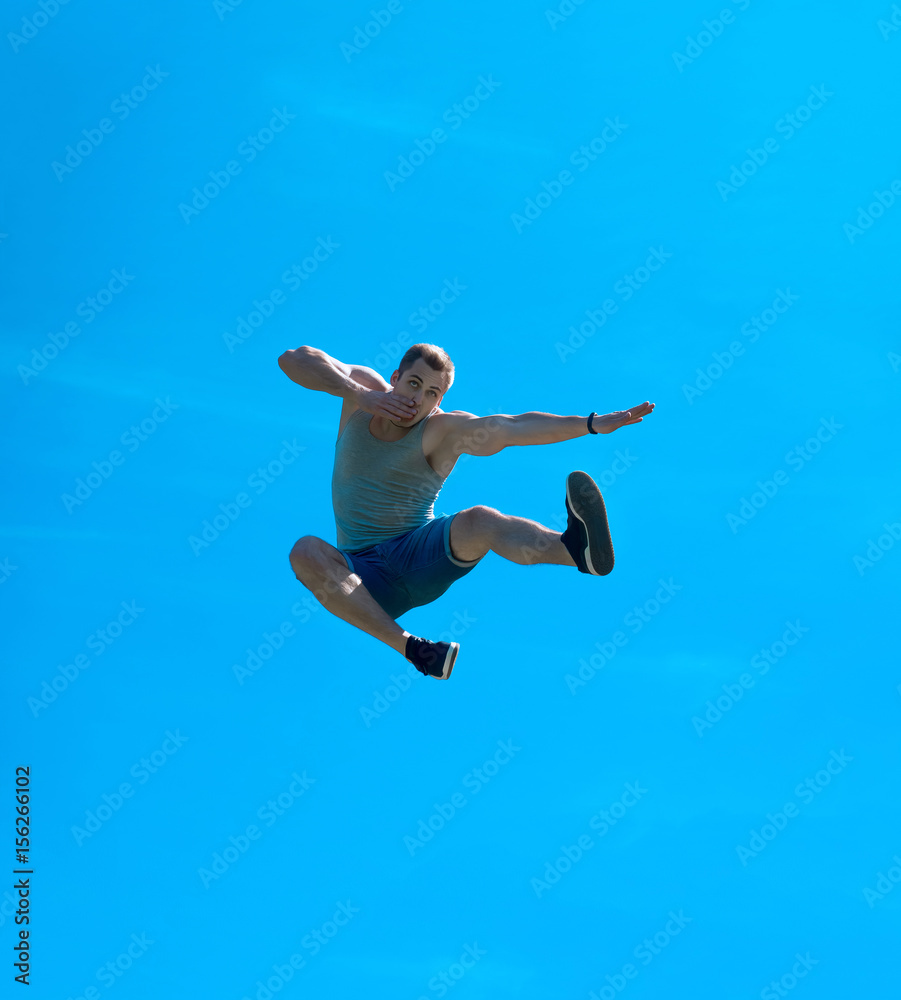 Jumping up guy. Background blue sky.