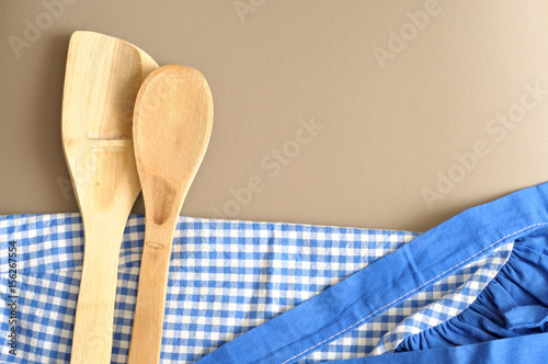 Two wooden spoon on a checkerd blue cloth photo