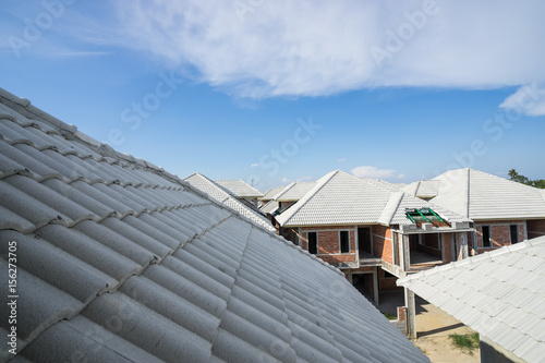 focus on roof on house construction on blue sky - can use to display or montage on product