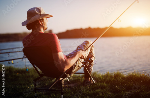 Tela Men fishing in sunset and relaxing while enjoying hobby