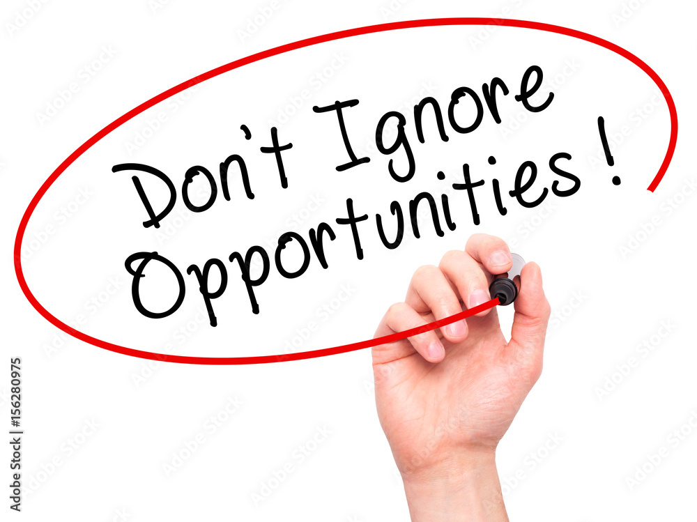 Fototapeta premium Man Hand writing Don't Ignore Opportunities black marker on visual screen