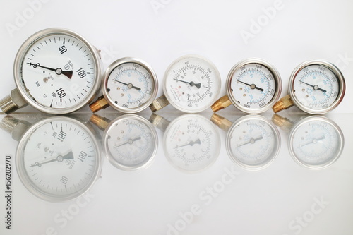 High pressure gauge meters or manometers for LNG or LPG natural gas distribution station plant or factory facility isolated on white background.Pressure gauge in oil and gas production process.