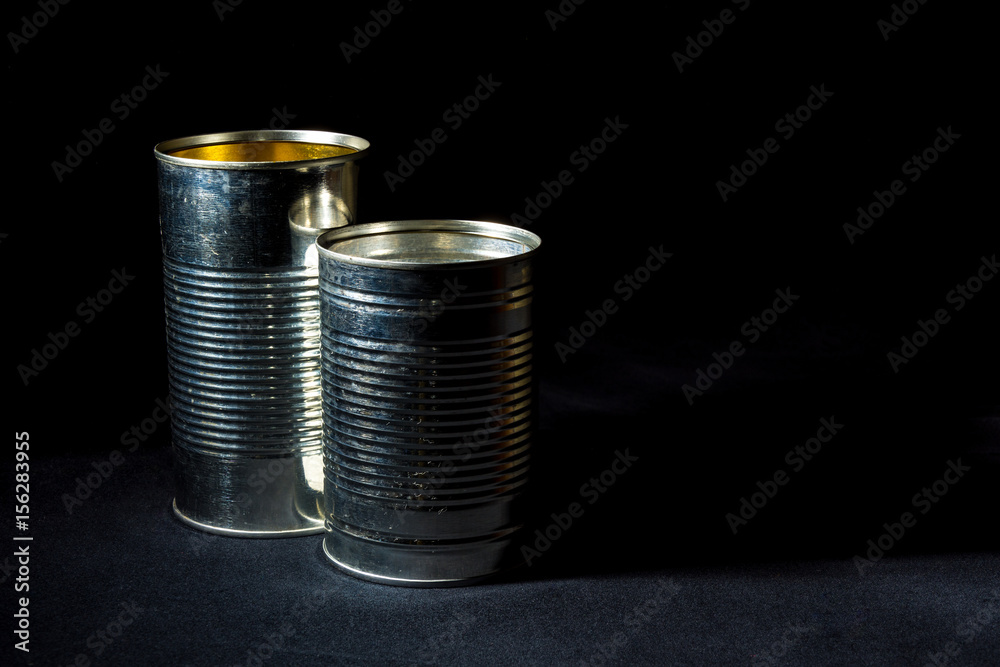 two empty tin cans for recycle on black background two empty tin cans for recycle on black background