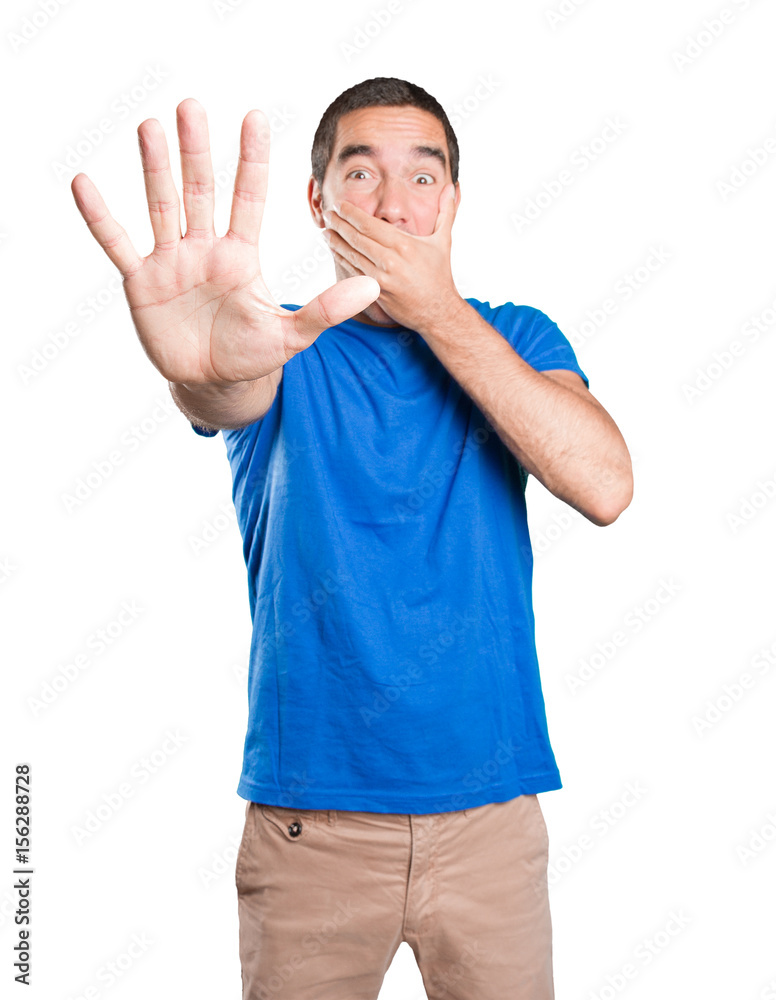 Scared young man against white background Scared young man against white background