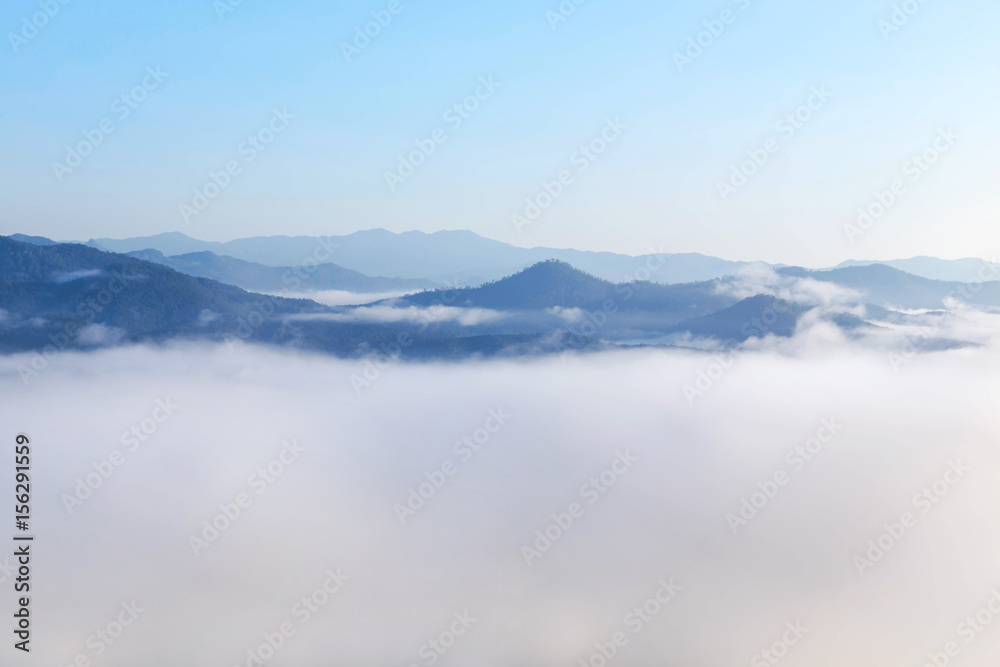   High angle view over tropical mountains with white fog in early morning in Thailand.
