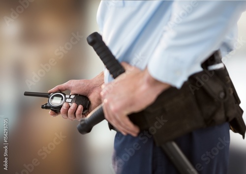 Photo security guard with walkie-talkie. blurred back