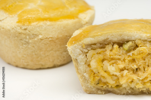 Two traditional Brazilian mini chicken pie called empada with one cut close