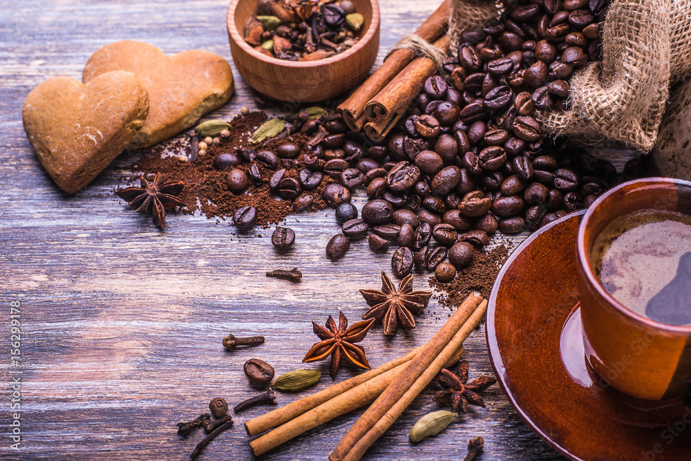 Coffee cup, coffee beans and biscuits, cookies in the shape of heart on wooden background Coffee cup, coffee beans and biscuits, cookies in the shape of heart on wooden background