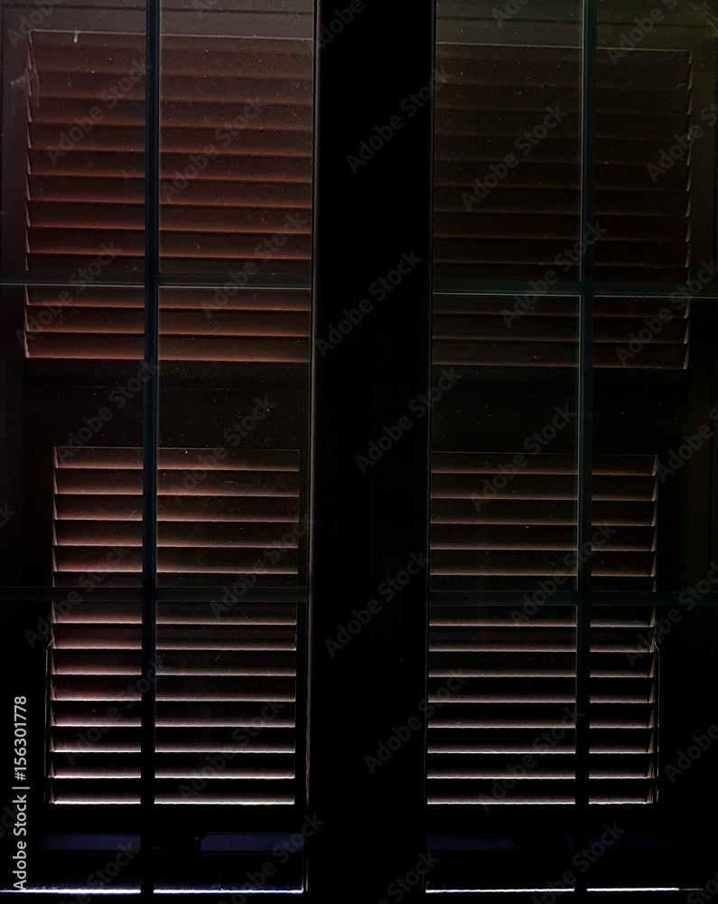 Light that filters between the closed shutters - obrazy, fototapety, plakaty 
