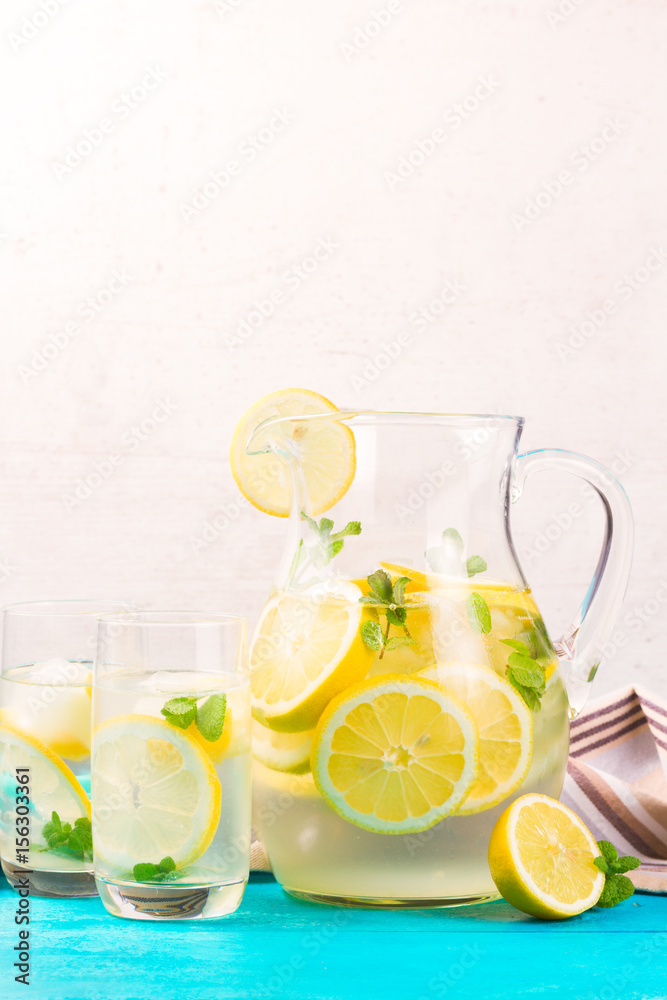 Lemonade homemade drink - jar and glasses on table Lemonade homemade drink - jar and glasses on table