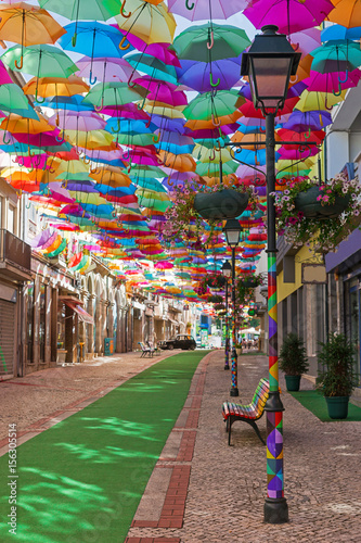 The sky of colorful umbrellas. Street with umbrellas. Umbrella Sky Project in Agueda, Aveiro district, Portugal. Street decorated with colored umbrellas, Agueda. photo