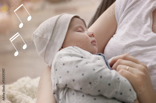 Vászonkép Young woman with cute sleeping baby at home, closeup