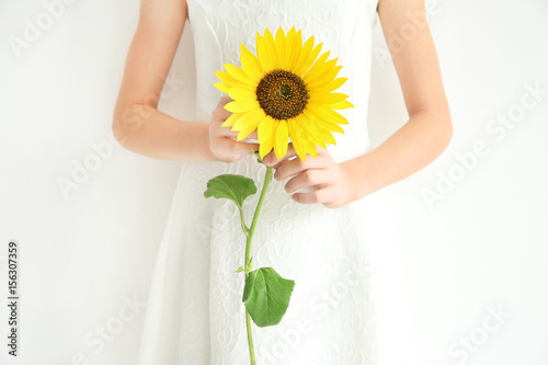Fototapeta Naklejka Na Ścianę i Meble -  Girl holding sunflower on white background