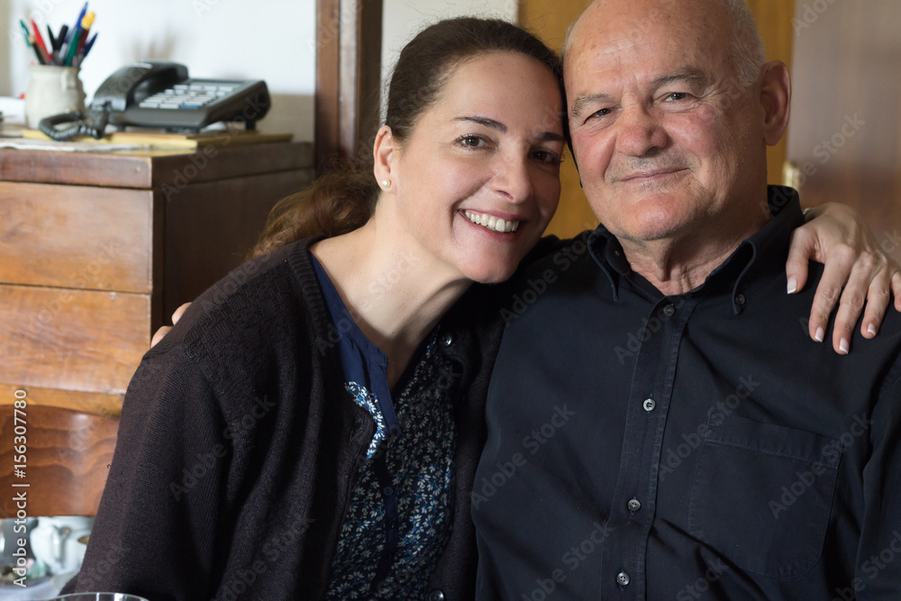 Portrait of a young woman and a senior man.
