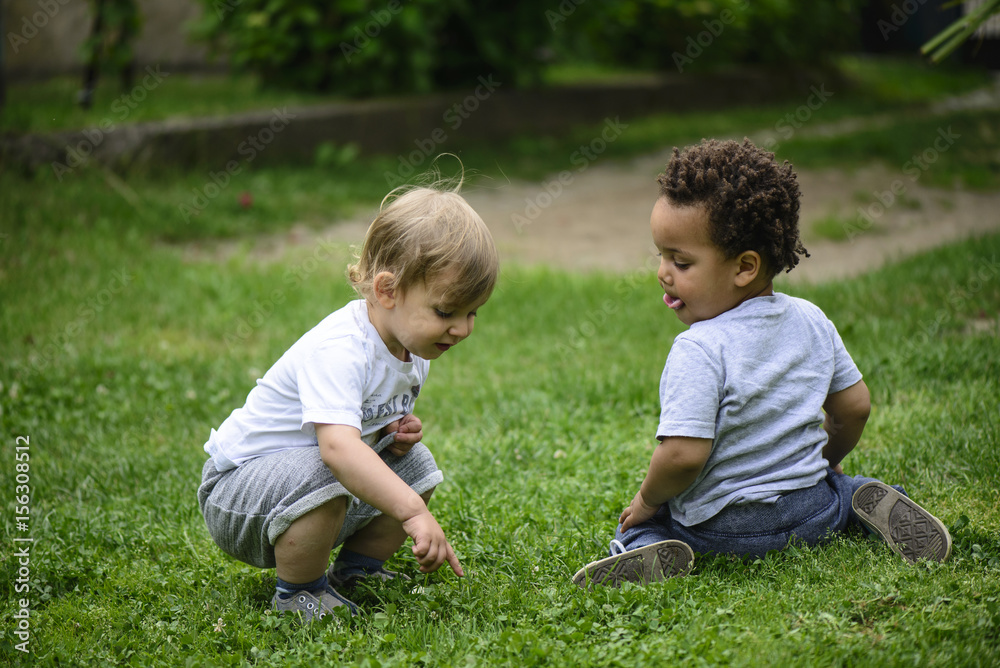 toddler boys playing outside, multi racial friendship toddler boys playing outside, multi racial friendship