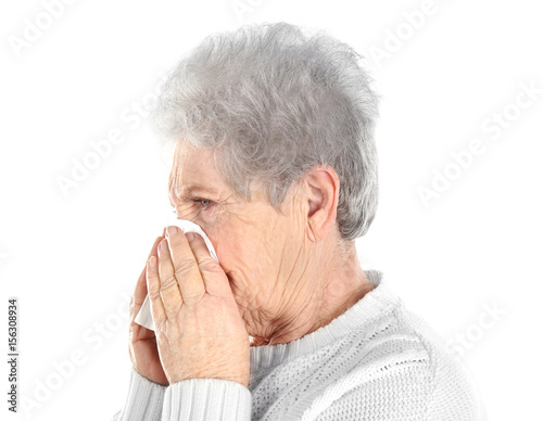 Mature ill woman with tissu...
