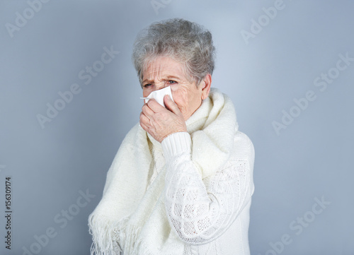 Mature ill woman with tissu...