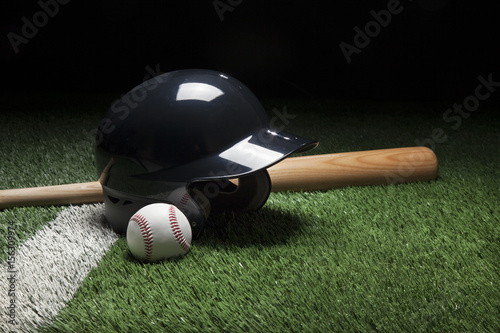 Baseball batting helmet bat and ball on field with stripe