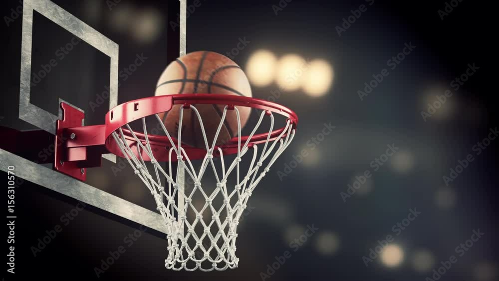 A throw in a basketball ring on the background of yellow spotlights A throw in a basketball ring on the background of yellow spotlights
