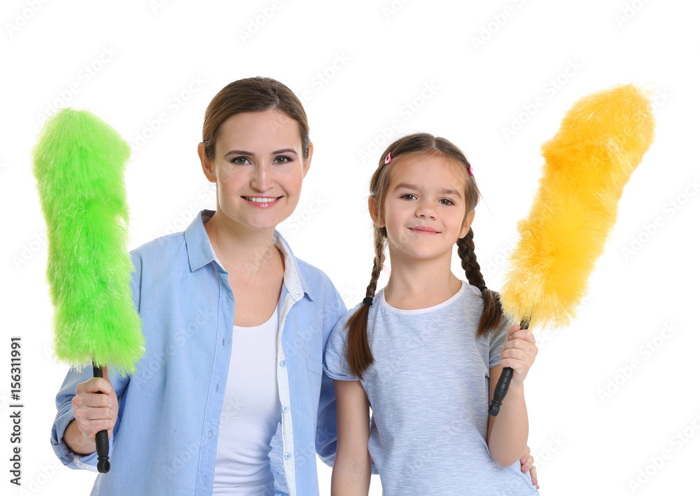Mother and daughter with dusters, isolated on white Mother and daughter with dusters, isolated on white