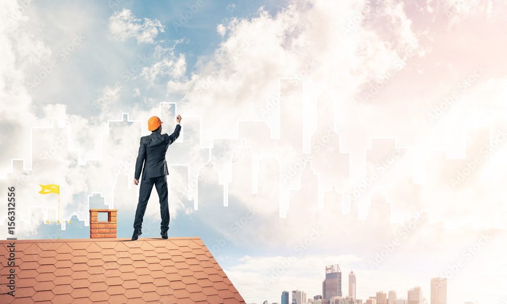 Man architect draw silhouette of modern city on blue sky. Mixed Man architect draw silhouette of modern city on blue sky. Mixed