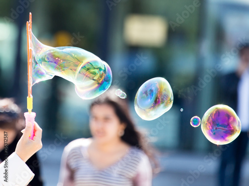 Beautiful soap bubbles fly in the city