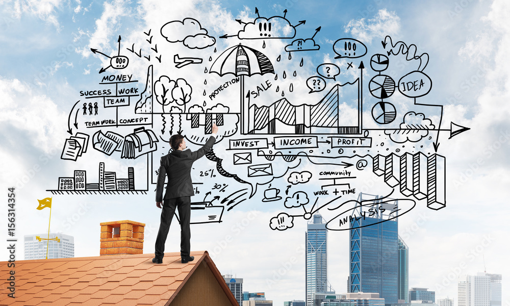 Rear view of businessman on house roof drawing his new business strategy. Mixed media Rear view of businessman on house roof drawing his new business strategy. Mixed media