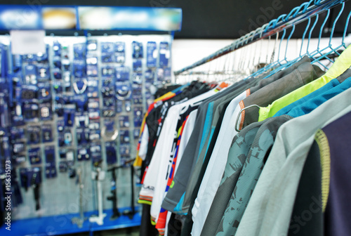 Rack with clothes on bicycle exhibition in showroom