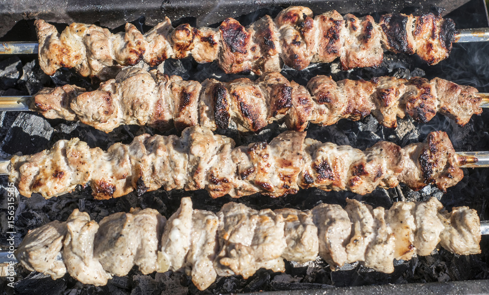 In the garden on a spit roast meat In the garden on a spit roast meat